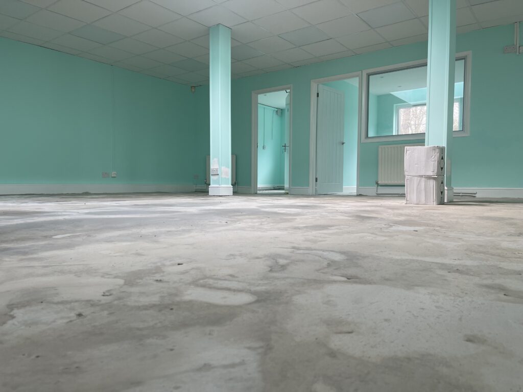 Old office flooring before carpet tile replacement