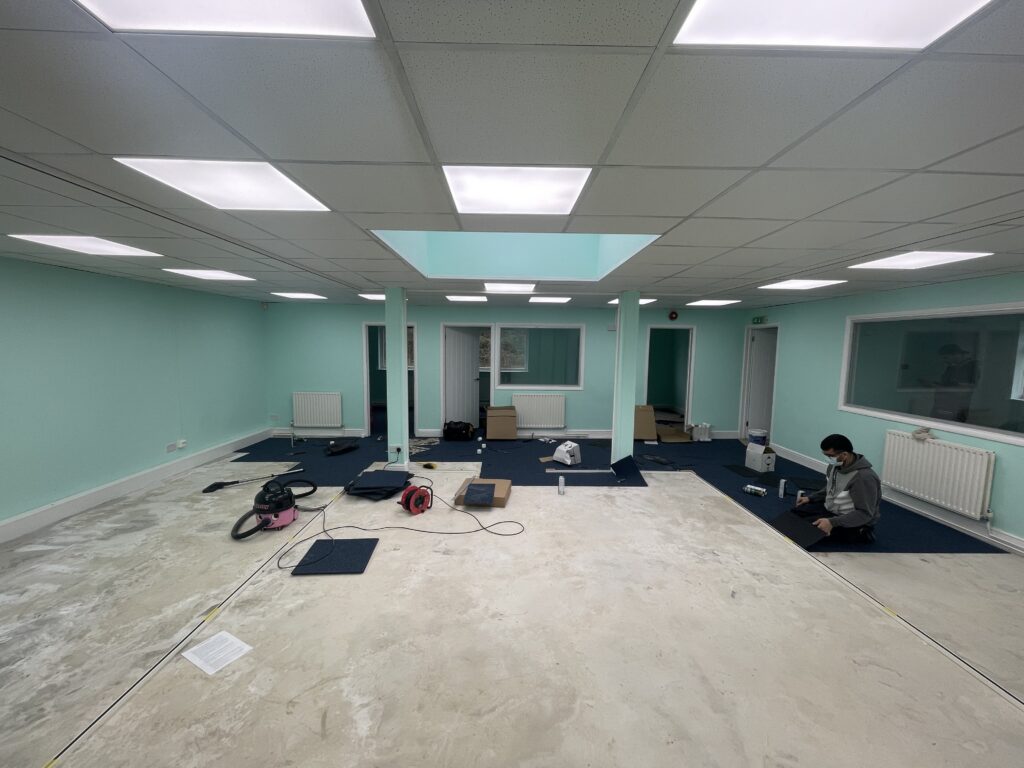 Close-up of commercial carpet tile fitting, office installation