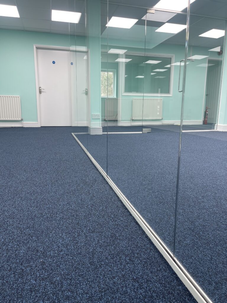 Close-up of commercial carpet tile fitting, office installation